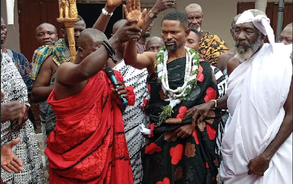 The newly installed paramount chief surrounded by  his divisional