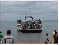 Hundreds of passengers use a dilapidated ferry at Dambai to transport goods