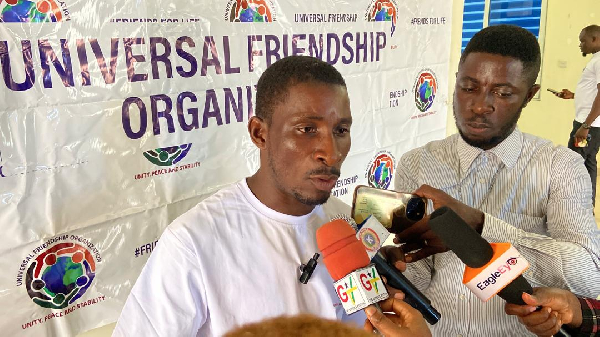 President of the Universal Friendship Organisation (UFO), Samuel Adobah (L)