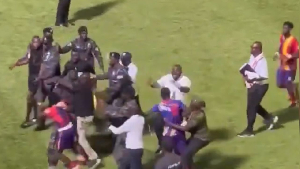 Police personnel escorted the referees out of the pitch during the chaos