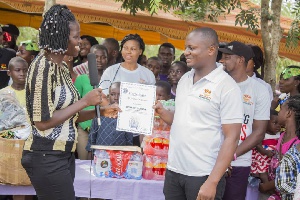 Wisdom Dordoe being honored by the leadership of the Royal Seed Orphanage after the event
