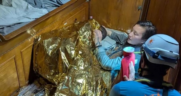 Rescuers with a water bottle and blankets tried to warm the girl up