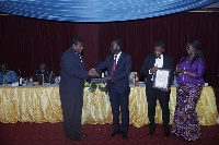 Outgoing Commissioner of Ghana Revenue Authority George Blankson presents award to Newmont