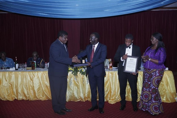 Outgoing Commissioner of Ghana Revenue Authority George Blankson presents award to Newmont