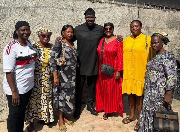 John Dumelo in a picture together with some school feeding caterers