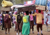 Some high school students on their way to school with luggages