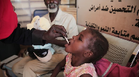 A Sudanese girl receives an oral cholera vaccine during a vaccination campaign