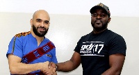 Merqury Quaye (right) in a pose with Ali Ajami, marketing Manager of Rush Energy