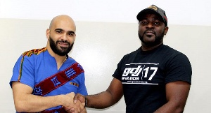 Merqury Quaye (right) in a pose with Ali Ajami, marketing Manager of Rush Energy
