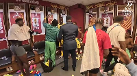 Asamoah Gyan (in suit), celebrating Ghana's win over Panama with the players