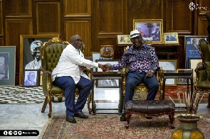 Joe Ghartey in a handshake with President John Agyekum Kufuor when they met
