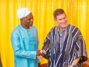 Robin Mearns (in Smock) shaking hands with the Northern Regional Minister
