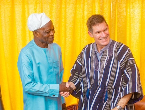 Robin Mearns (in Smock) shaking hands with the Northern Regional Minister