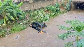 Taxi submerged in drain at Madina Warehouse