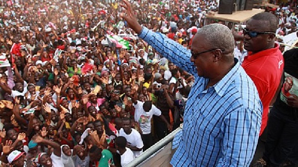 President John Mahama waving at a crowd during one of his campaign tour