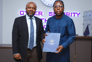 Edem (R) with an official of the Cyber Security Authority