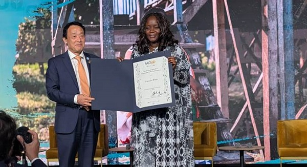 Chef Fatmata Binta (R) standing with Director-General QU Dongyu