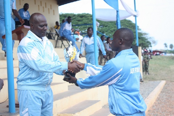 Flying Officer Anala (right) receiving the overall best trophy from Group Capt Mike Appiah Agyekum