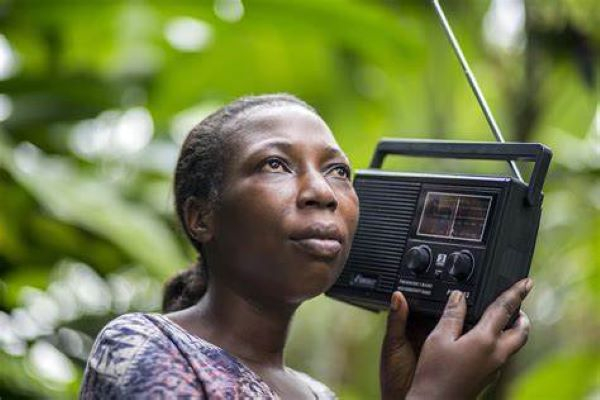 File photo of a woman listening to radio broadcast