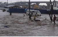 People struggle through flood to safety.