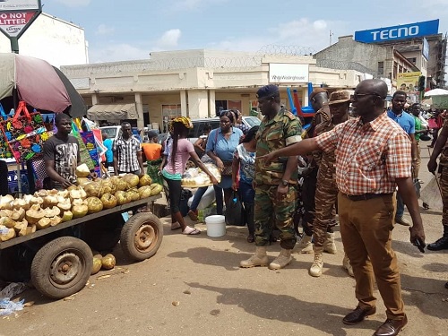 Osei Assibey warning a coconut seller who plied his trade in the road at Adum