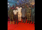 Otumfuo Osei Tutu II with his security officials during a royal dinner