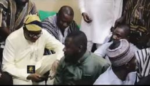 John Jinapor (close to the man wearing white clothing) kneels, begging the Yaa Naa for forgiveness