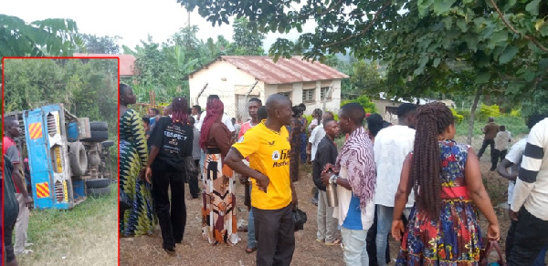 Inset is the wreckage of the truck while in the main picture are people gathered at mortuary