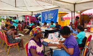 People are seen going through health screening