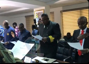 Asiedu Nketia in black suit and red tie taking the oath of office alongside other board members