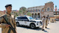 People gather as a US hovercraft prepares to evacuate residents from Janzur, Libya