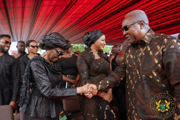 The late Nana Konadu Agyeman-Rawlings (L) and President John Mahama (R) shaking hands