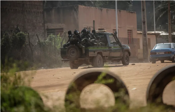 A Guinea-Bissau security forces patrol car drives through the area of incidents with protesters