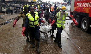 Rescuers carry body of victim