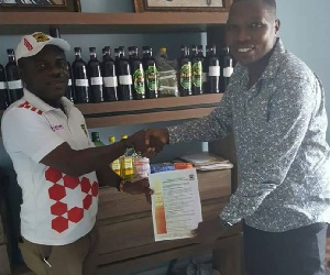 Charger Limited;producers of Happy Man Bitters with a representative from Kumasi Asante Kotoko