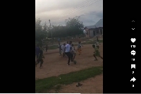 John Paintsil (in white) with the young footballers on the grassless pitch