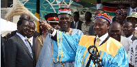 Prime Minister Raila Odinga looks on while Ugandan President Yoweri Museveni is crowned as Luo elder