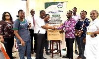 Workers at the Korle Bu Polyclinic (R) receiving a donation from the Drewgees Foundation (L)