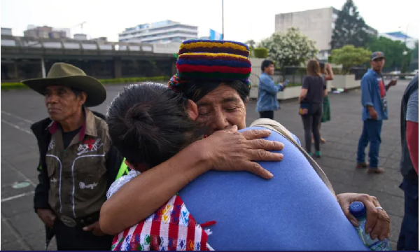 An Indigenous woman is embraced by an activist in Guatemala City after the conviction and sentence