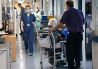 File photo of medics and a patient in a chair
