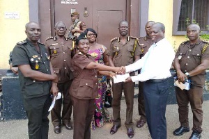 Dr Ernest Puni Kwarko in a shot with some Prison officials