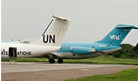 A Wimbi Diri aircraft sits on the runway behind a United Nations plane at the airport in Kisangani
