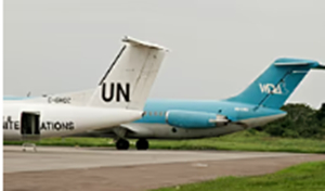 A Wimbi Diri aircraft sits on the runway behind a United Nations plane at the airport in Kisangani