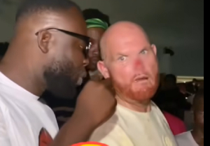 According to Greg (R), the incident occurred while he was attempting to move closer to the stage