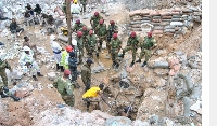 Zambian army special forces officers follow the rescue operation of miners
