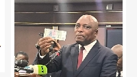 Zimbabwe's central bank governor John Mushayavanhu shows off the new currency