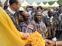 Kwabena Minta Akandoh being supported to official cut tape for the health centre to be opened