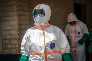 Health workers wearing protective equipment gather to disinfect isolation area for Ebola patients Health workers wearing protective equipment gather to disinfect isolation area for Ebola patients