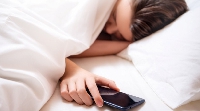 File photo of a lady sleeping with a mobile device