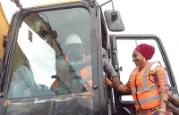 Amoako-Attah moving a tractor to symbolically start the project